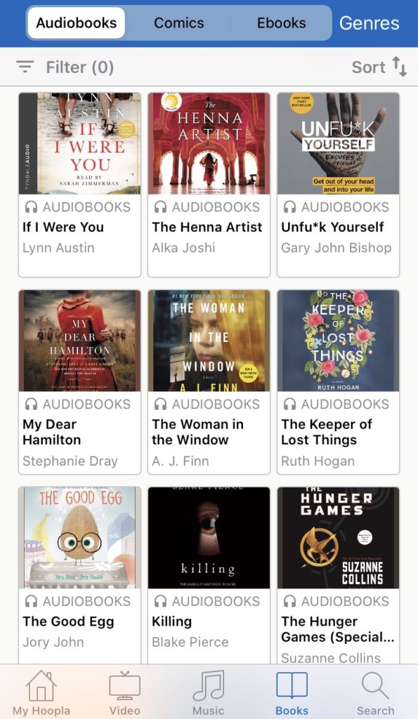 Hoopla digital library app displaying popular audiobooks like The Woman in the Window and The Hunger Games, in Palo Alto, California.